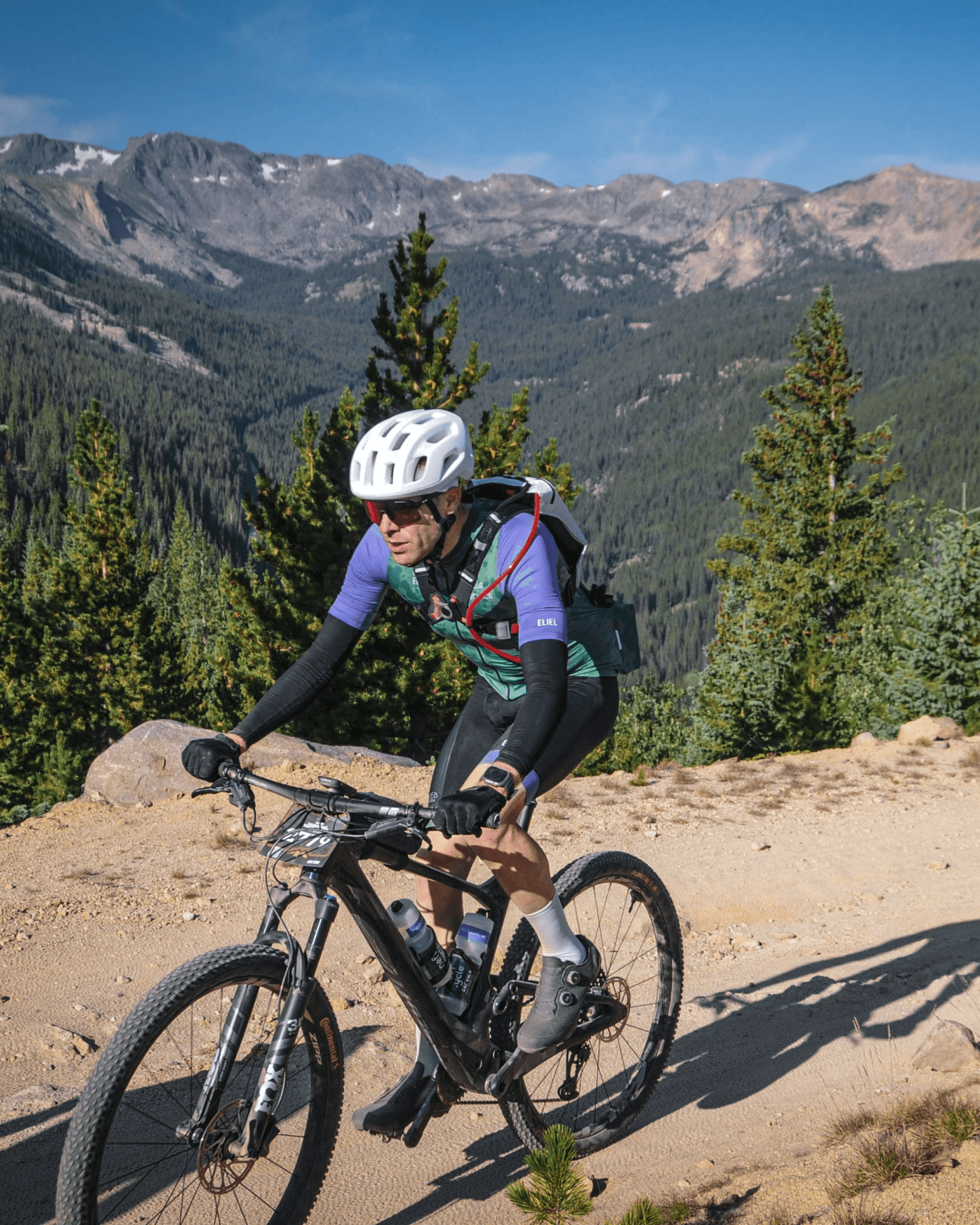 Chris Winterhack racing at the Leadville 100 MTB with Colorado mountains in the background